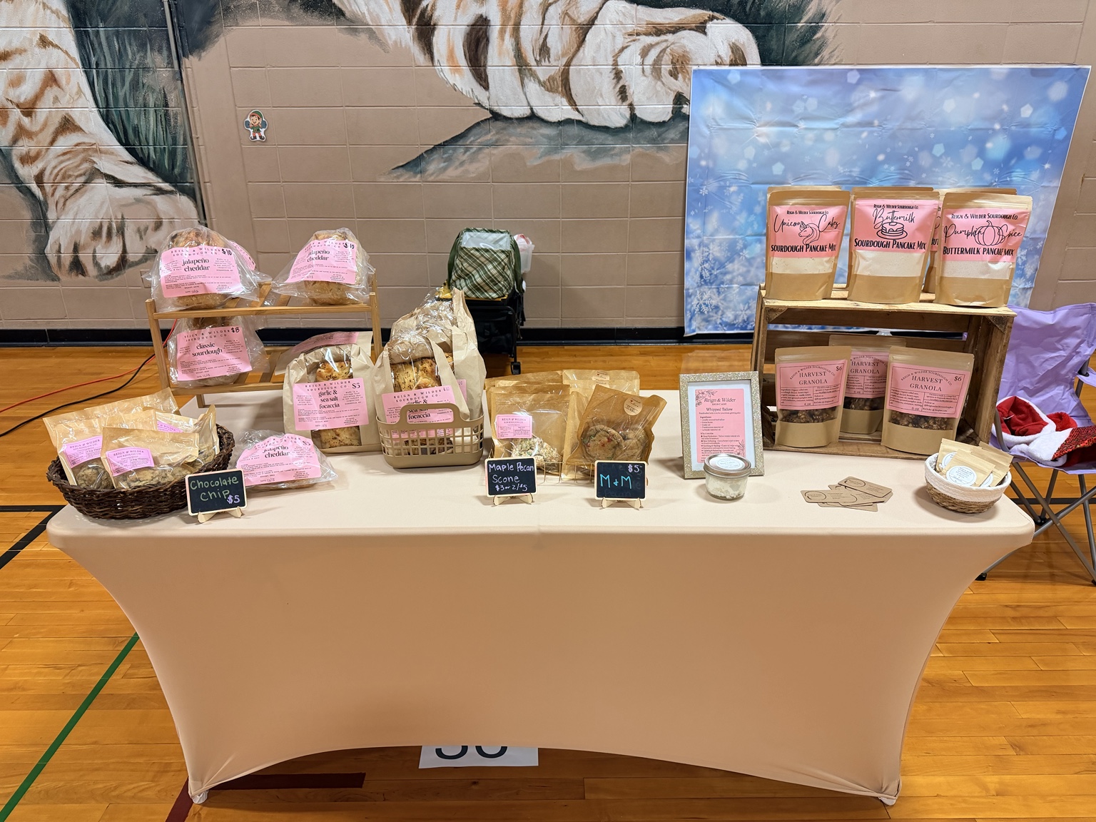 Reign & Wilder bakery booth at an Ozark Missouri market with customers shopping